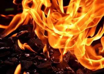 Burning coals with bright, swirling flames.