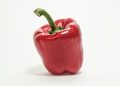 Red bell pepper on white background.
