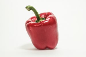 Red bell pepper on white background.
