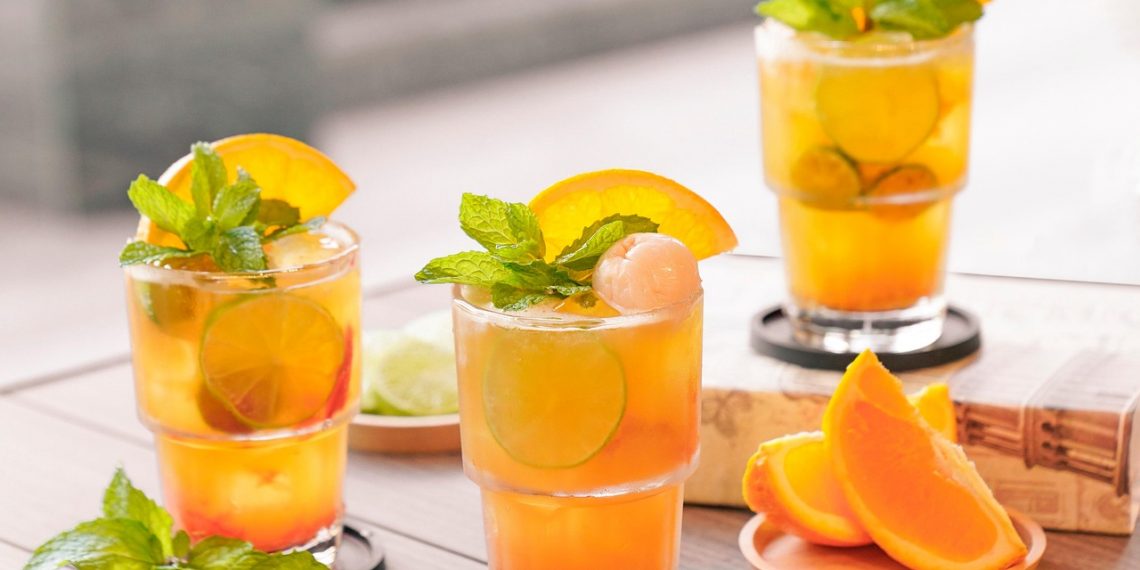 Refreshing citrus cocktails garnished with mint and orange slices.