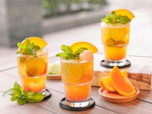 Refreshing citrus cocktails garnished with mint and orange slices.
