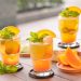 Refreshing citrus cocktails garnished with mint and orange slices.