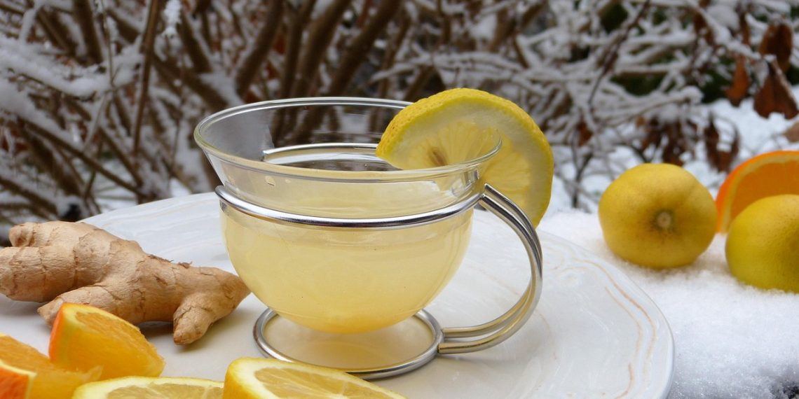 Warm lemon ginger tea with fresh citrus and ginger on a snowy day.
