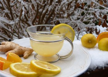 Warm lemon ginger tea with fresh citrus and ginger on a snowy day.