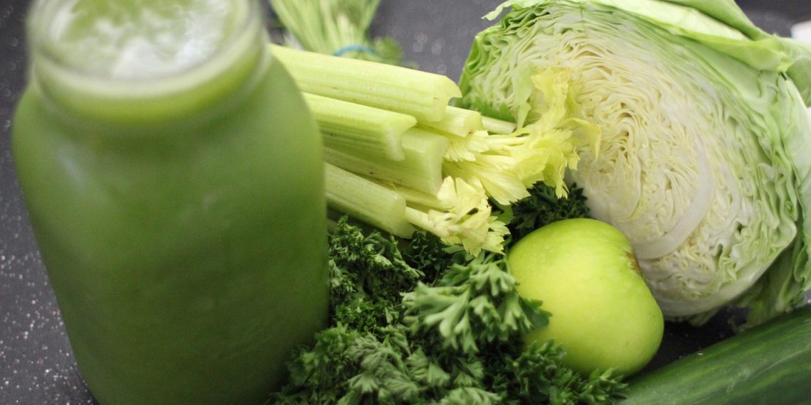 Green smoothie ingredients including celery, cabbage, apple, and greens.