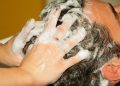 Hair washing with shampoo and massage.
