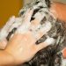 Hair washing with shampoo and massage.