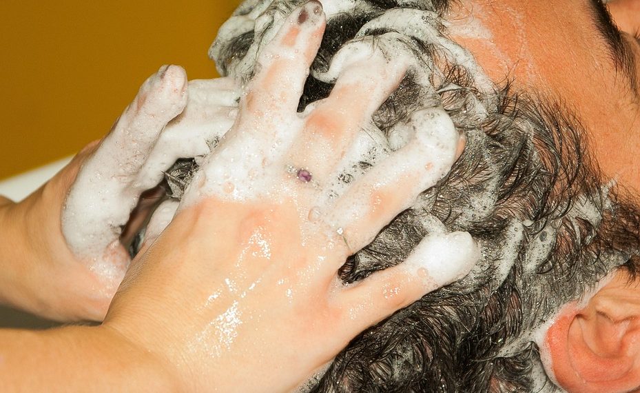 Hair washing with shampoo and massage.