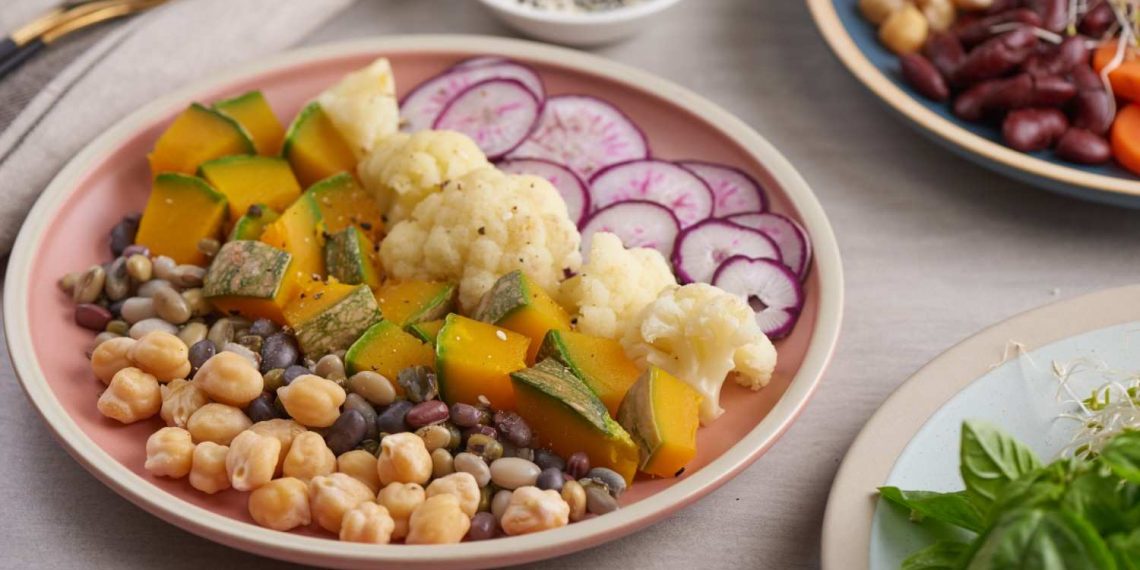 Mixed legume and vegetable salad with radishes and pumpkin slices.