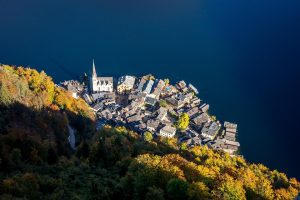 Aerial view of Hallstatt village by a lake in autumn.