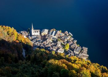 Aerial view of Hallstatt village by a lake in autumn.