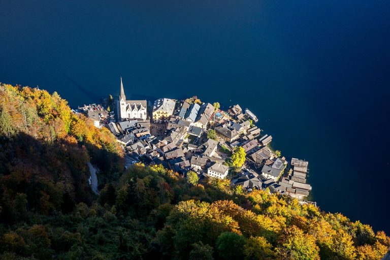 Aerial view of Hallstatt village by a lake in autumn.