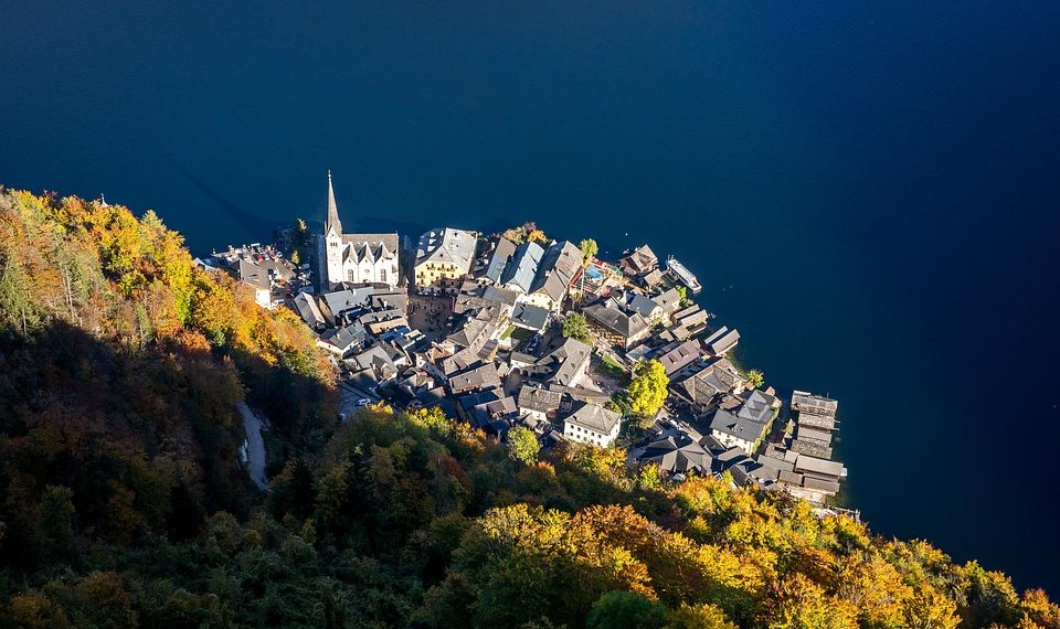 Aerial view of Hallstatt village by a lake in autumn.