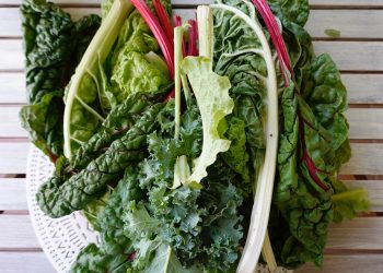 Fresh leafy greens on a wooden table.