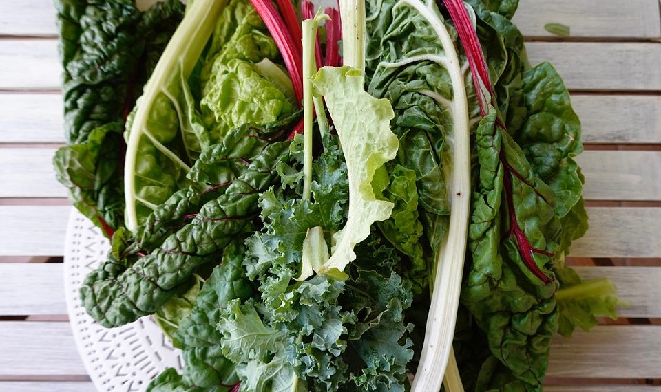 Fresh leafy greens on a wooden table.