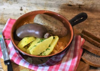 Rustic sausage stew with potatoes and herbs.