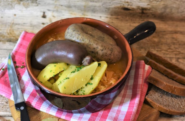 Rustic sausage stew with potatoes and herbs.