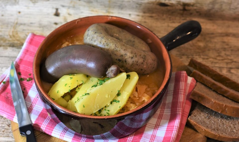 Rustic sausage stew with potatoes and herbs.