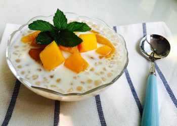 Creamy tapioca pudding topped with mango and mint leaves.