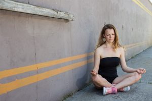 Woman meditating in yoga pose outdoors