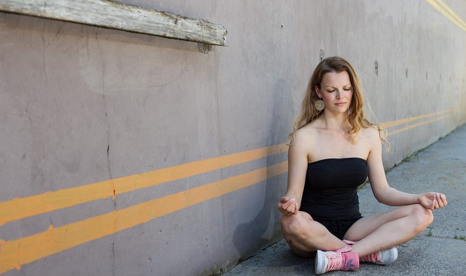 Woman meditating in yoga pose outdoors