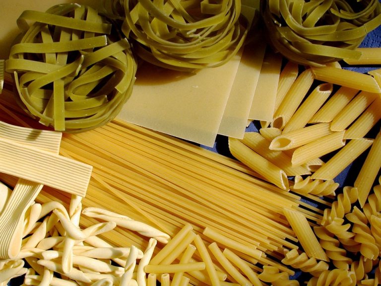 Assorted uncooked pasta varieties, including penne and tagliatelle.