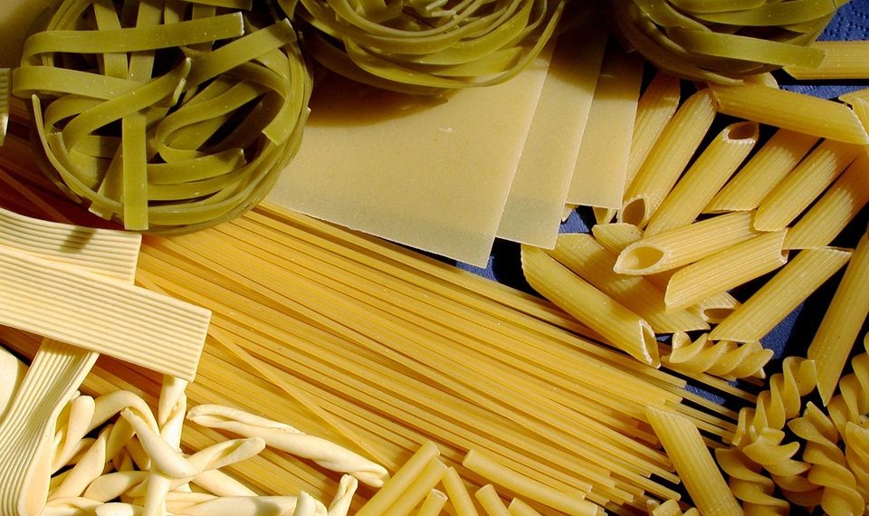 Assorted uncooked pasta varieties, including penne and tagliatelle.