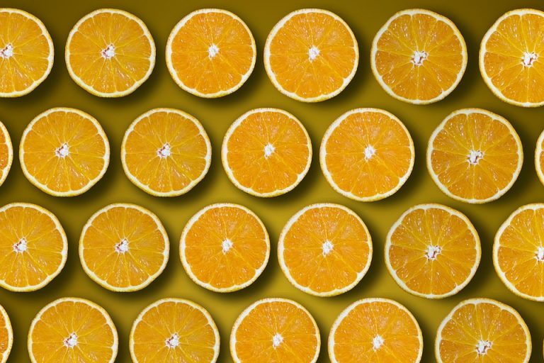 Sliced oranges pattern on a yellow background.