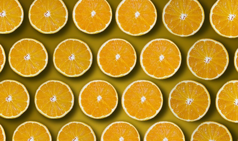 Sliced oranges pattern on a yellow background.