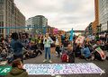 Protesters gather in Berlin street advocating for climate action.