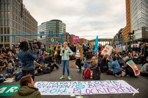 Protesters gather in Berlin street advocating for climate action.