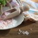 Pink Himalayan salt in wooden scoop on the table.