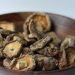 Dried shiitake mushrooms in a wooden bowl.