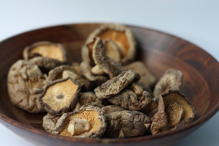 Dried shiitake mushrooms in a wooden bowl.