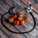 Stethoscope encircles fresh strawberries on wooden table.