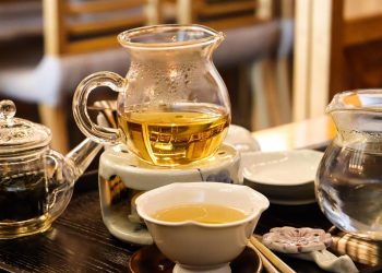 Brewing herbal tea in a glass teapot set for relaxing teatime.