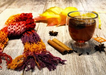 Cozy autumn tea with cinnamon, star anise, and a colorful knitted scarf.