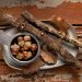Acorns and sticks on rustic table setting.
