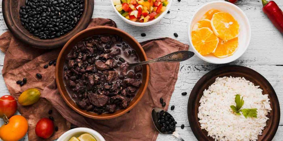 Black bean stew with white rice and fresh vegetables.