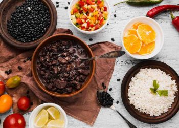 Black bean stew with white rice and fresh vegetables.
