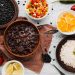 Black bean stew with white rice and fresh vegetables.
