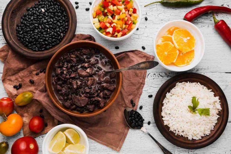 Black bean stew with white rice and fresh vegetables.