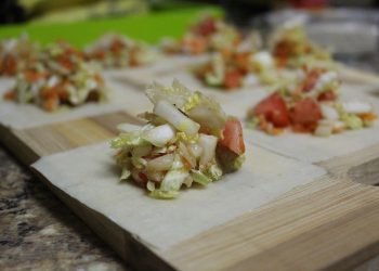 Fresh vegetable filling on dumpling wrappers.