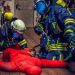 Firefighters performing a rescue drill with a dummy.