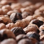 Shelled walnuts in a pile, highlighting texture.