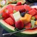 Fruit salad in watermelon bowl with diverse fresh fruits.