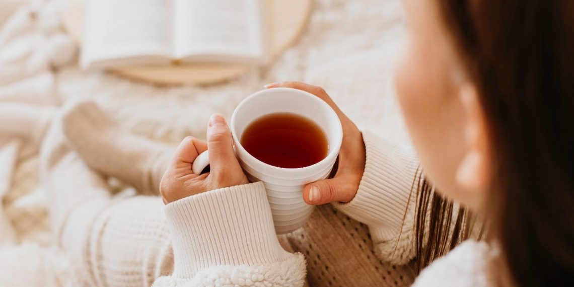 Cozy morning with a book and hot tea.