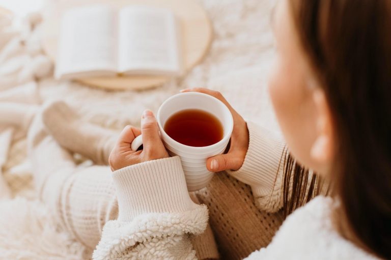 Cozy morning with a book and hot tea.