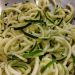 Zucchini noodles in a colander, perfect for a healthy low-carb meal.