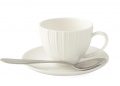 White ceramic teacup with spoon on matching saucer.